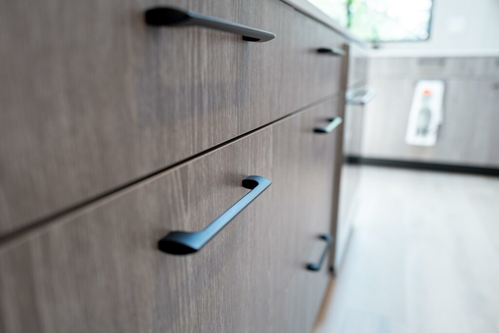Modern kitchen cabinet handles in close-up view.