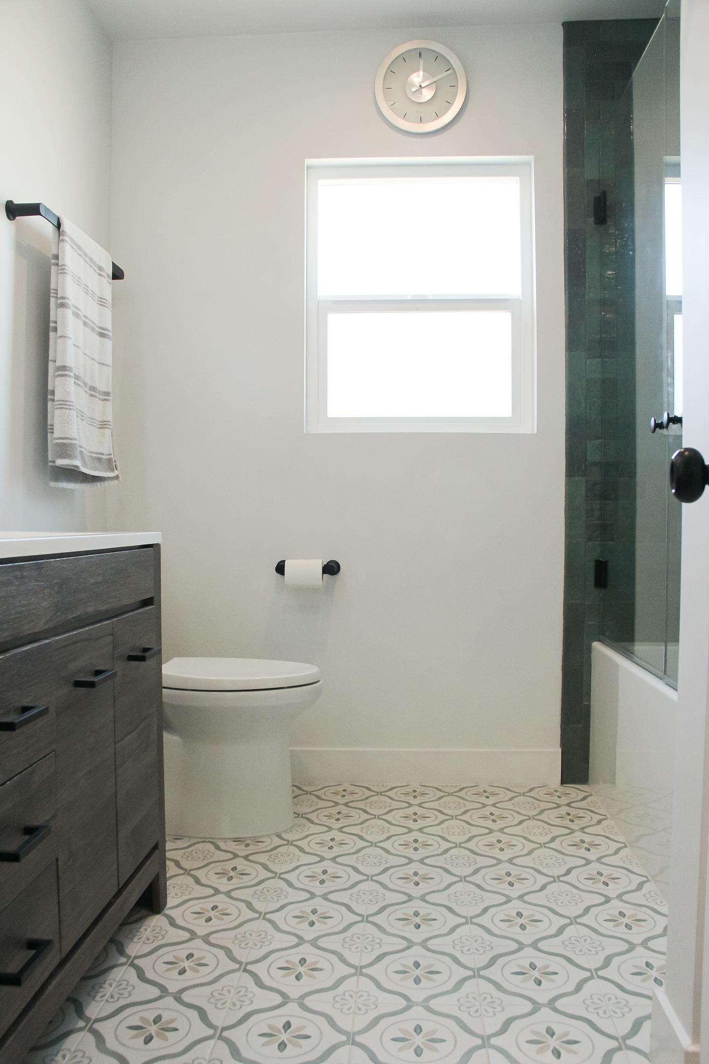 Modern bathroom interior with patterned floor tiles.