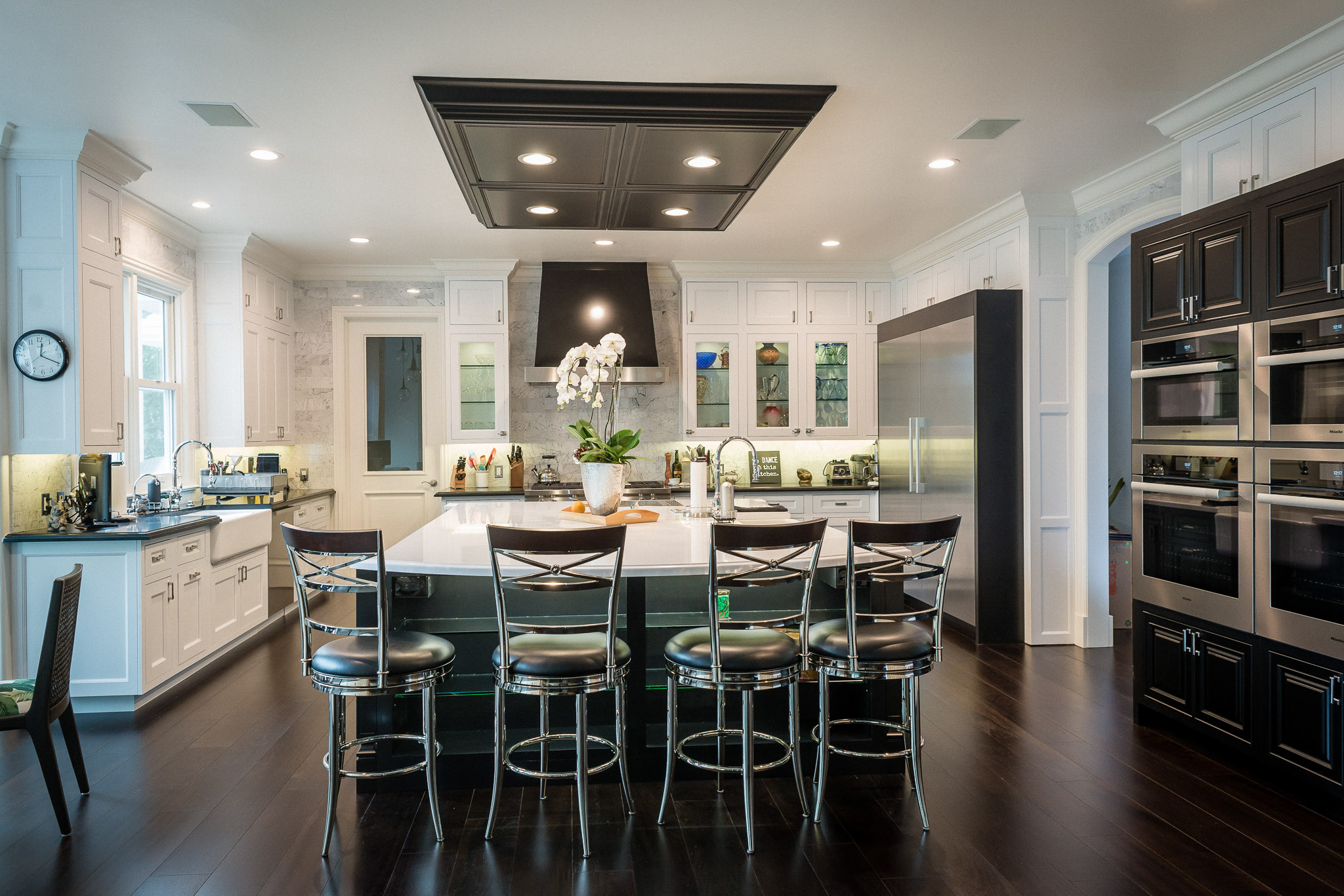 Modern kitchen with island and bar stools.