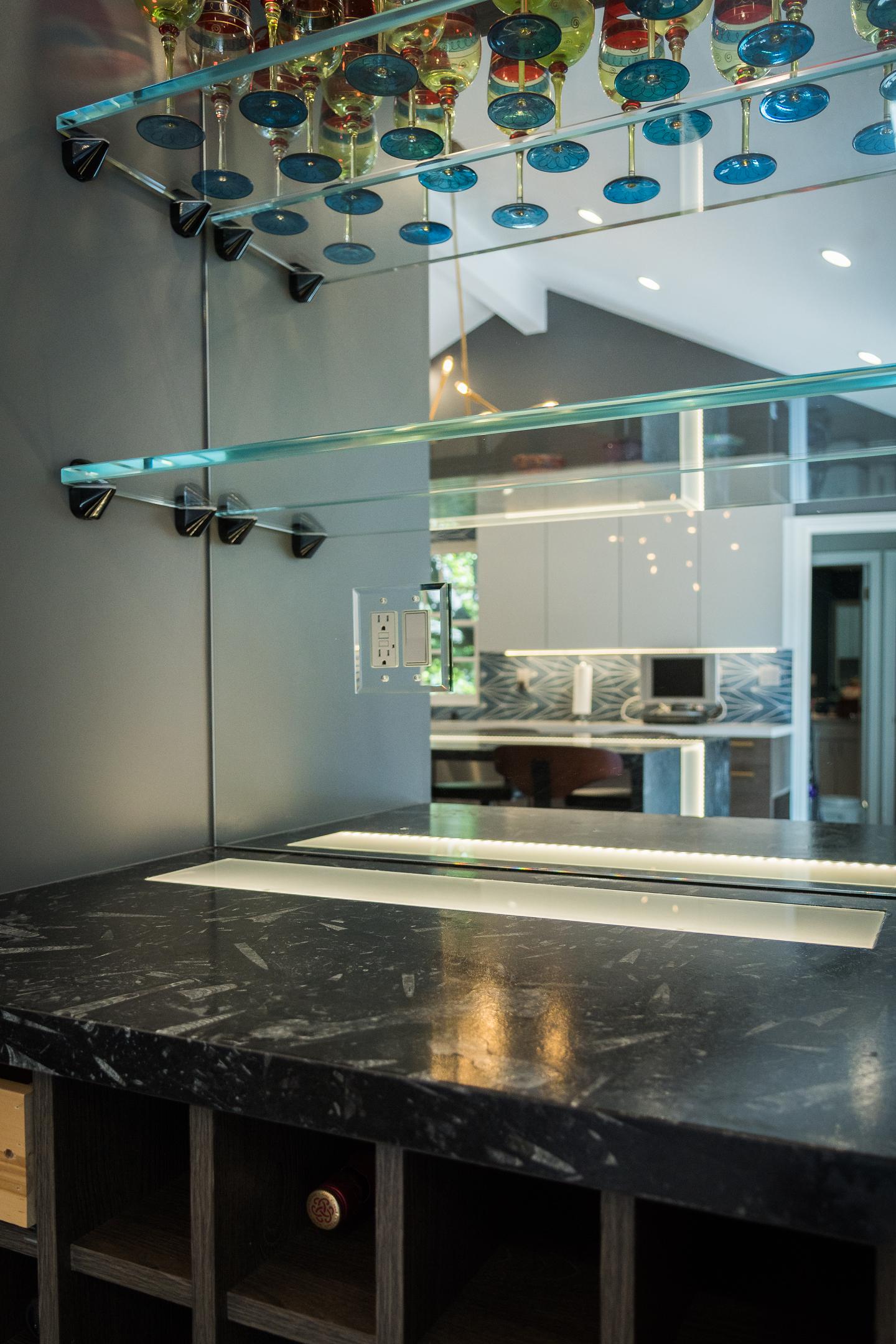Modern kitchen with glass wine rack over island