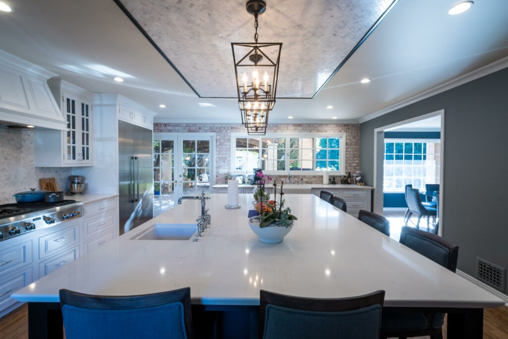 Modern kitchen interior with island and pendant lighting.