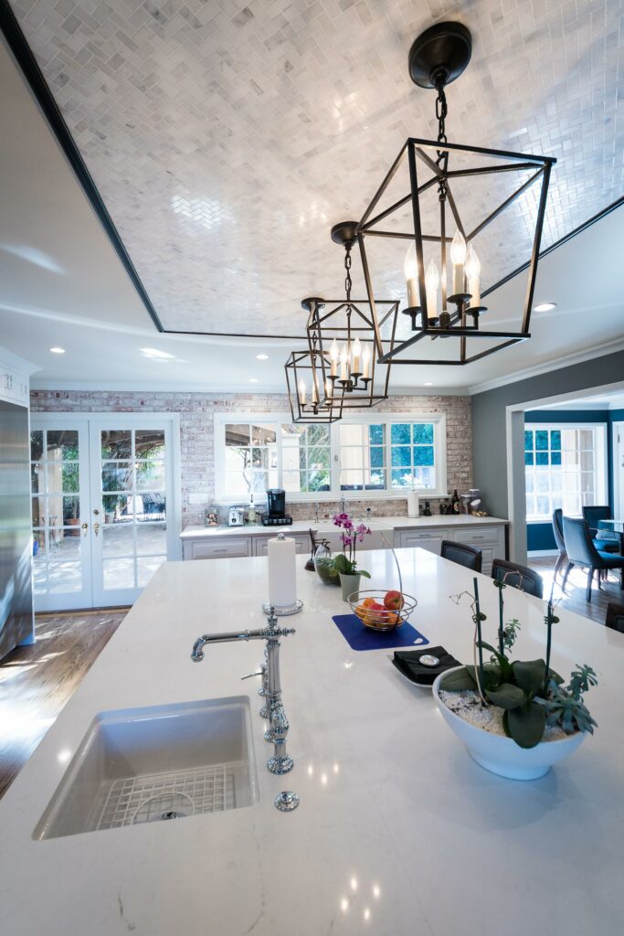 Modern kitchen interior with island and elegant pendant lights.