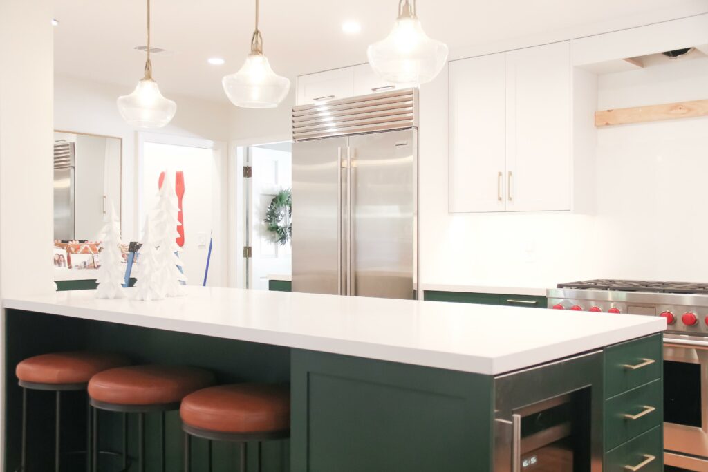 Modern kitchen with island and pendant lights.
