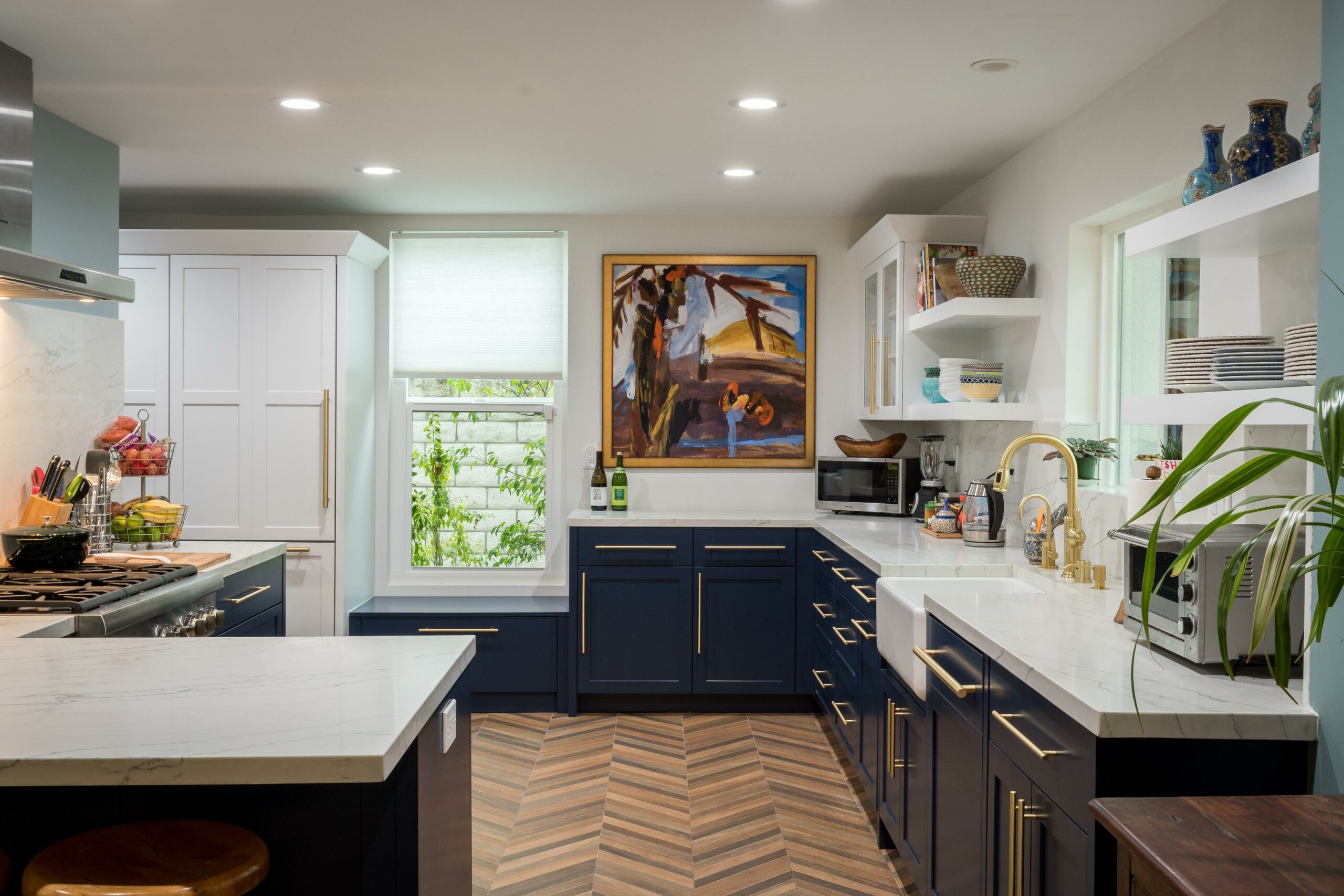 Modern kitchen interior with white and navy cabinets.