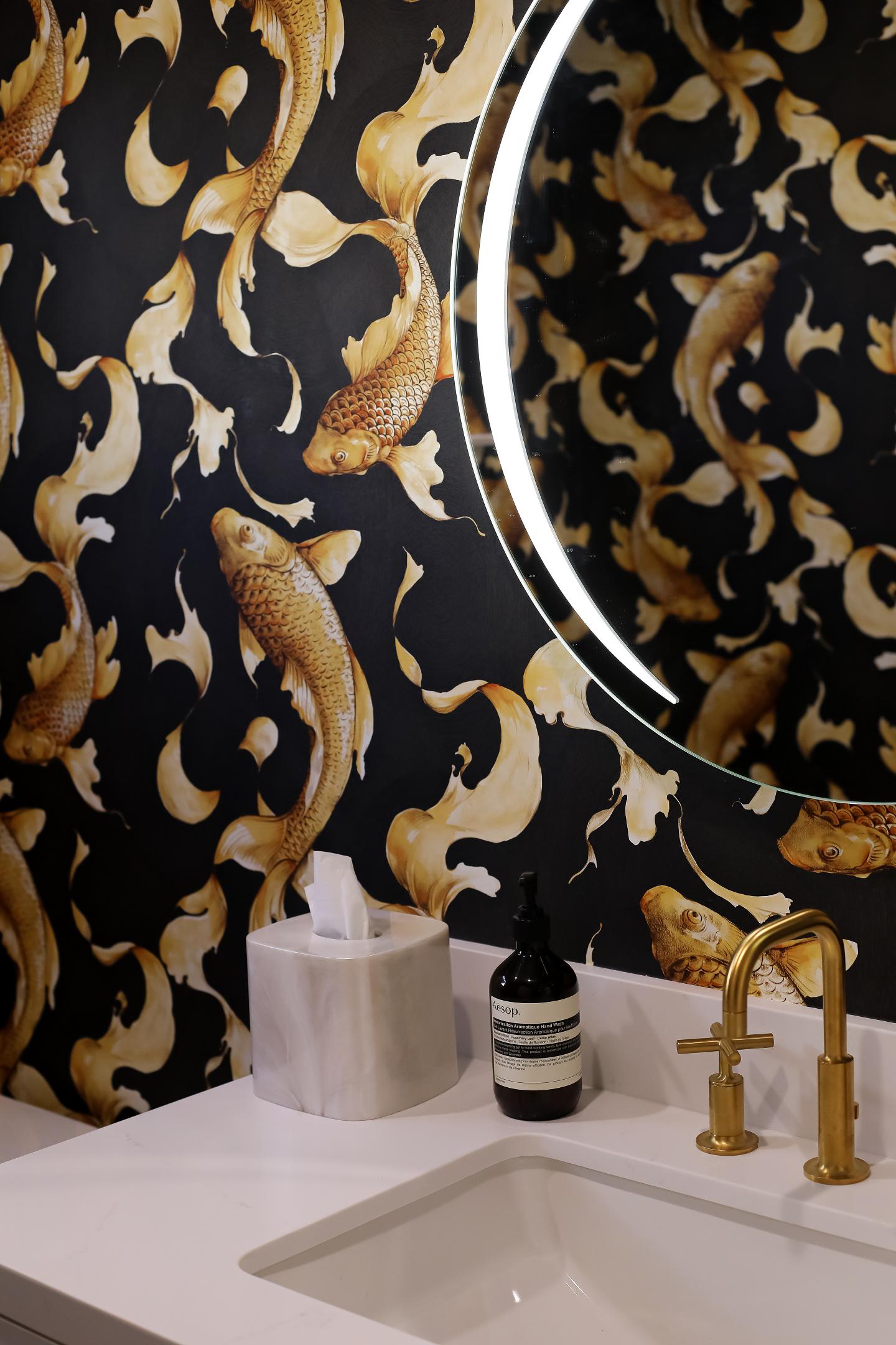 Elegant bathroom with koi fish wallpaper and gold fixtures.