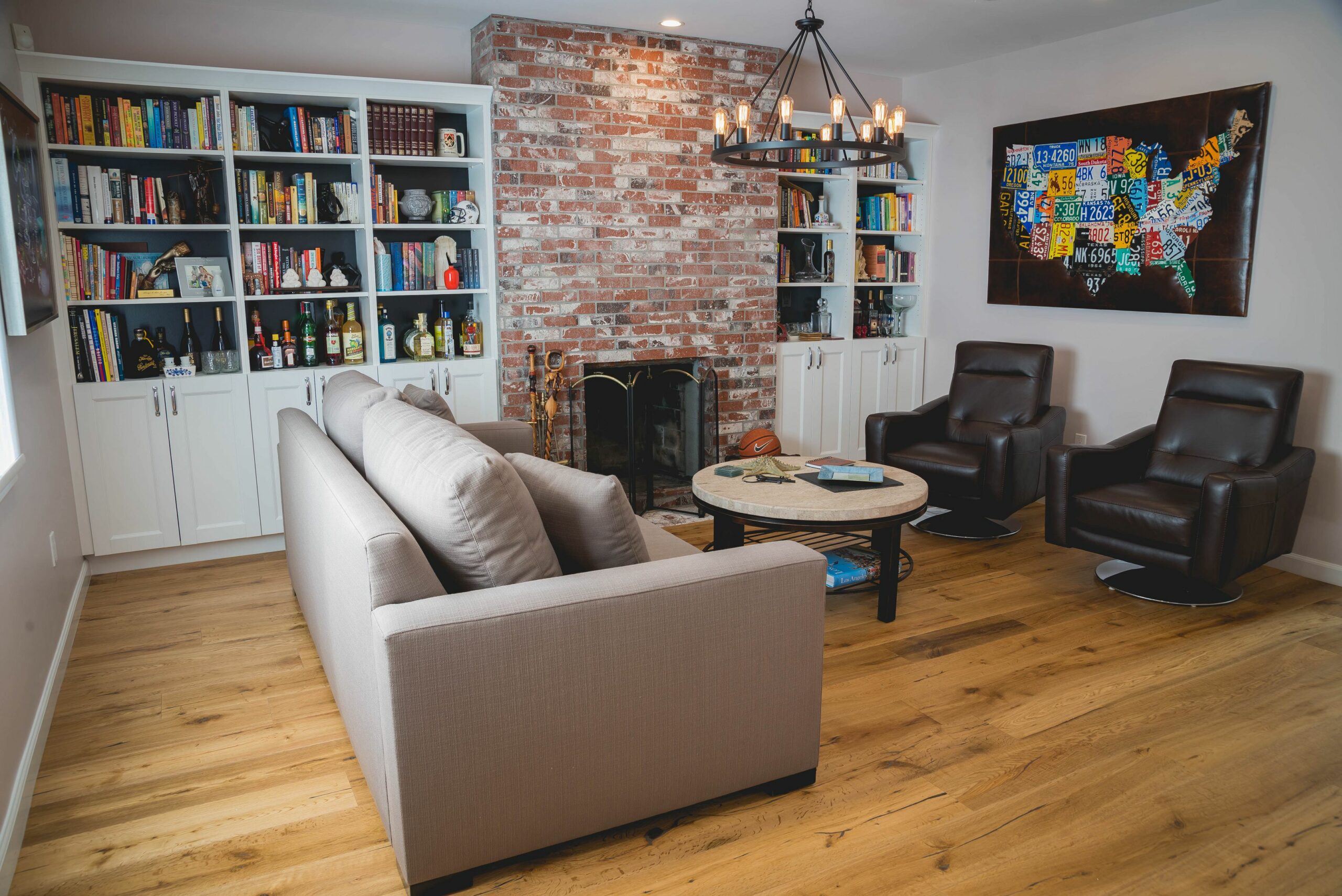Cozy living room with brick wall and bookshelf decor.