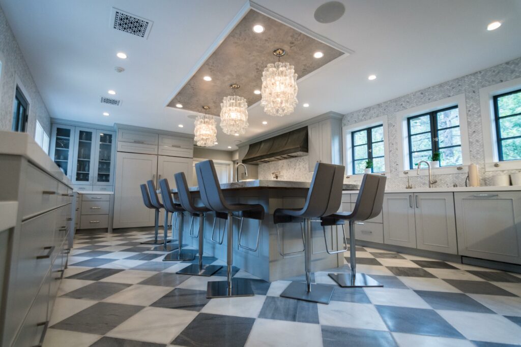 Elegant modern kitchen with island and bar stools.