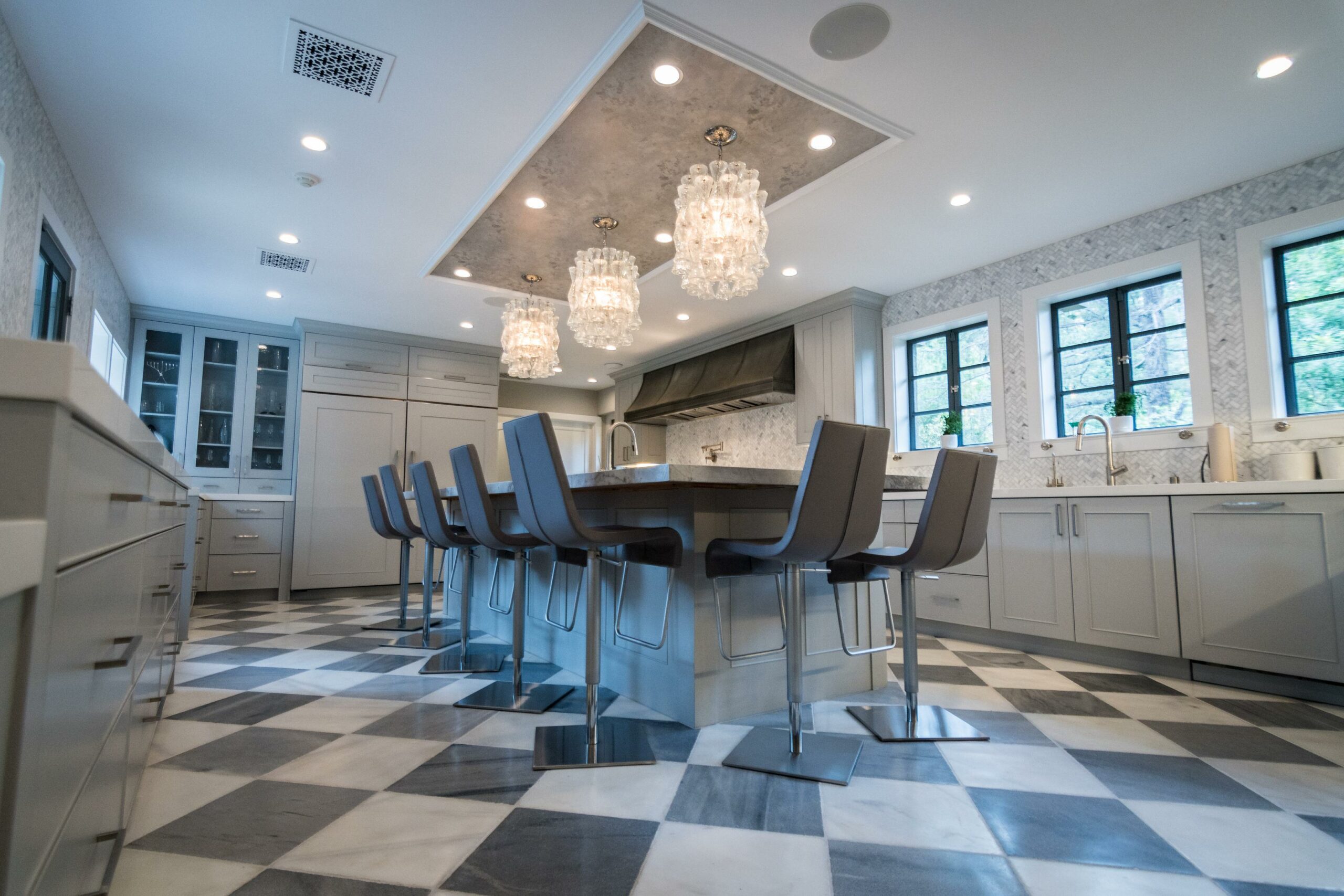 Elegant modern kitchen with island and bar stools.