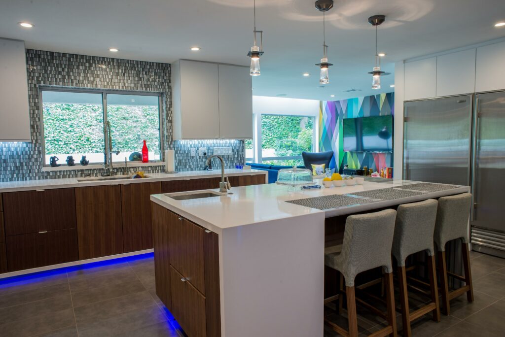Modern kitchen interior with island and LED lighting.