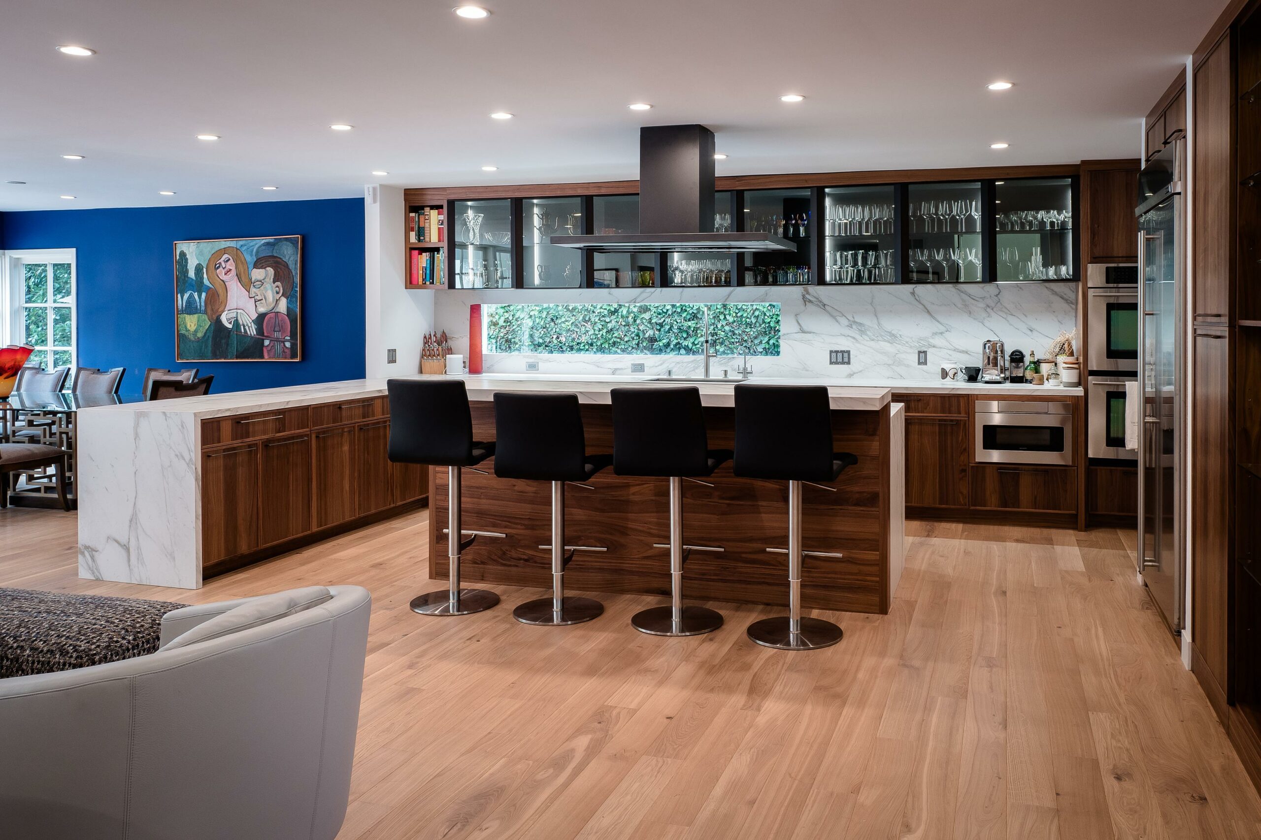 Modern kitchen interior with island and bar stools.