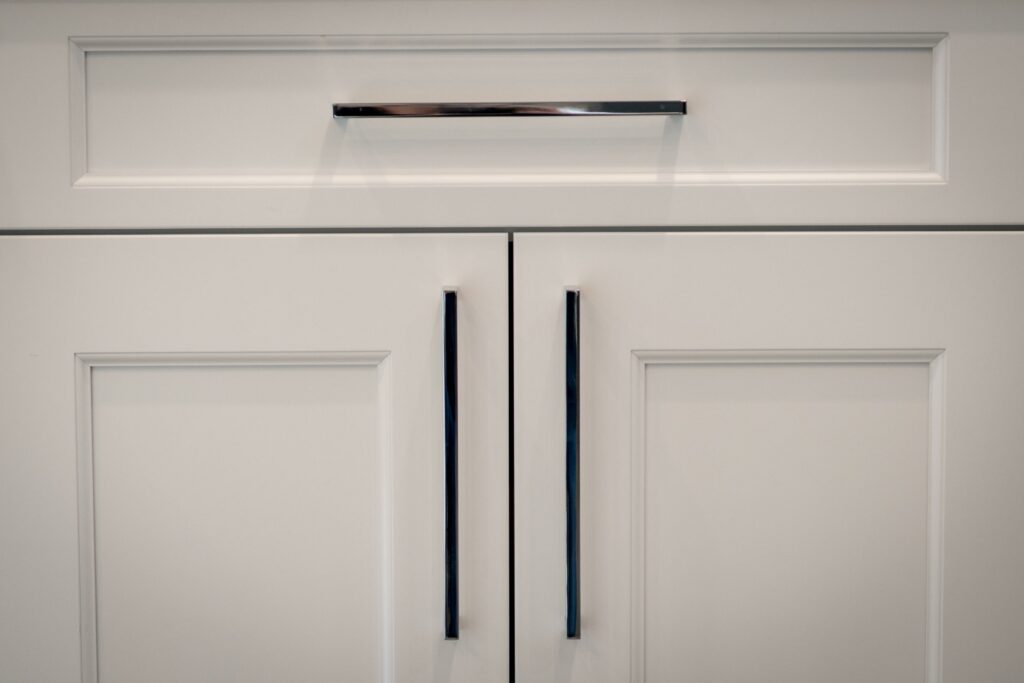White kitchen cabinet doors with modern handles.