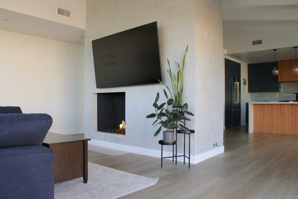 Modern living room with fireplace and mounted TV.