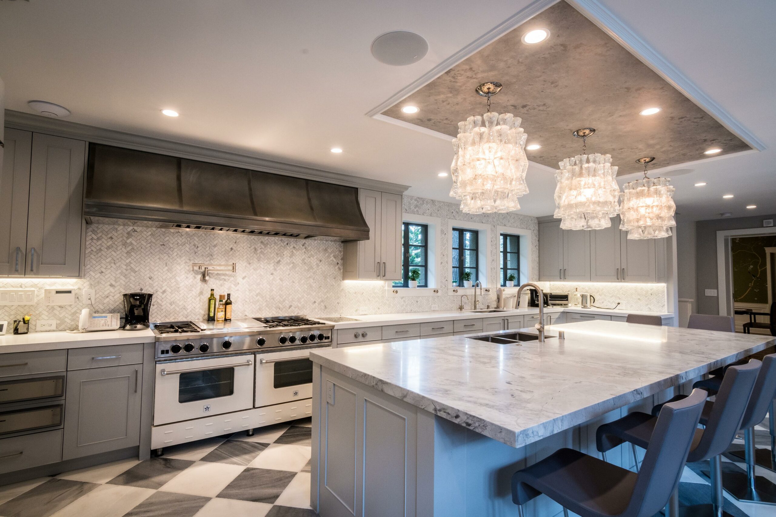 Modern kitchen interior with island and elegant light fixtures