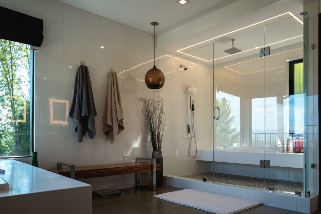Modern bathroom interior with glass shower and towels.