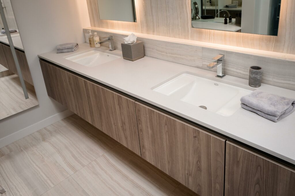 Modern bathroom with double sink and mirror.