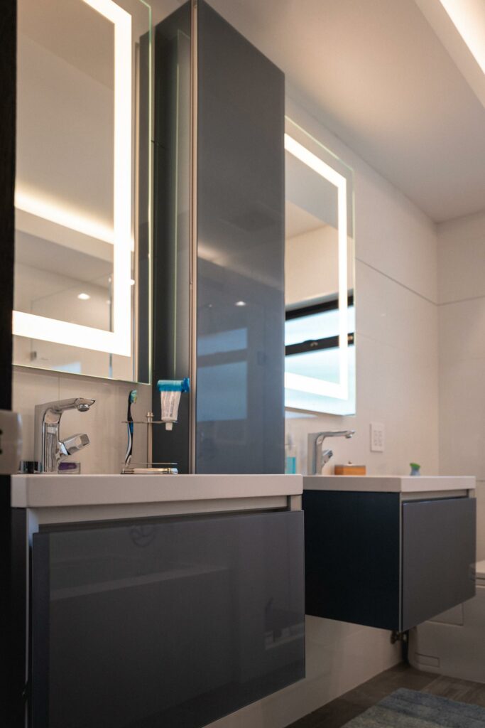 Modern bathroom vanity with illuminated mirror.