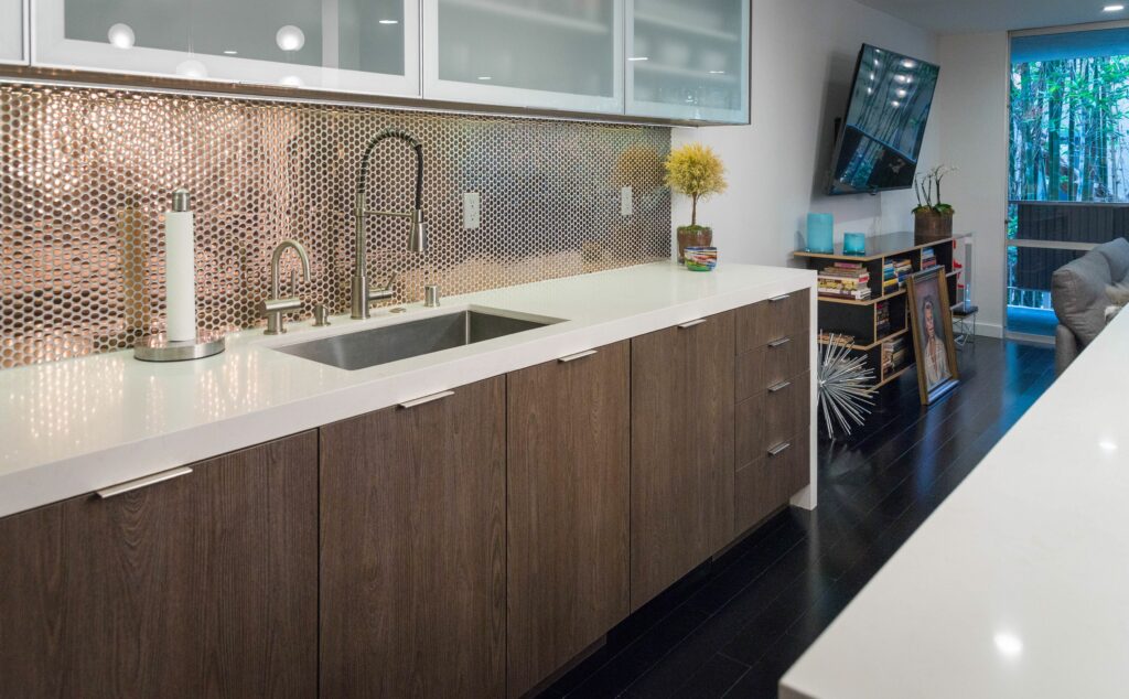 Modern kitchen with copper backsplash and wood cabinets.