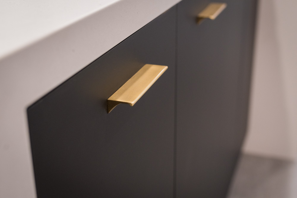 Gold handle on black cabinet_drawer.
