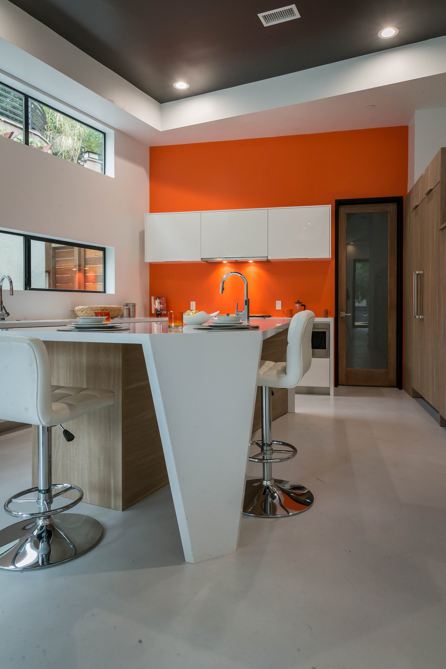 Modern kitchen with orange walls and white furniture