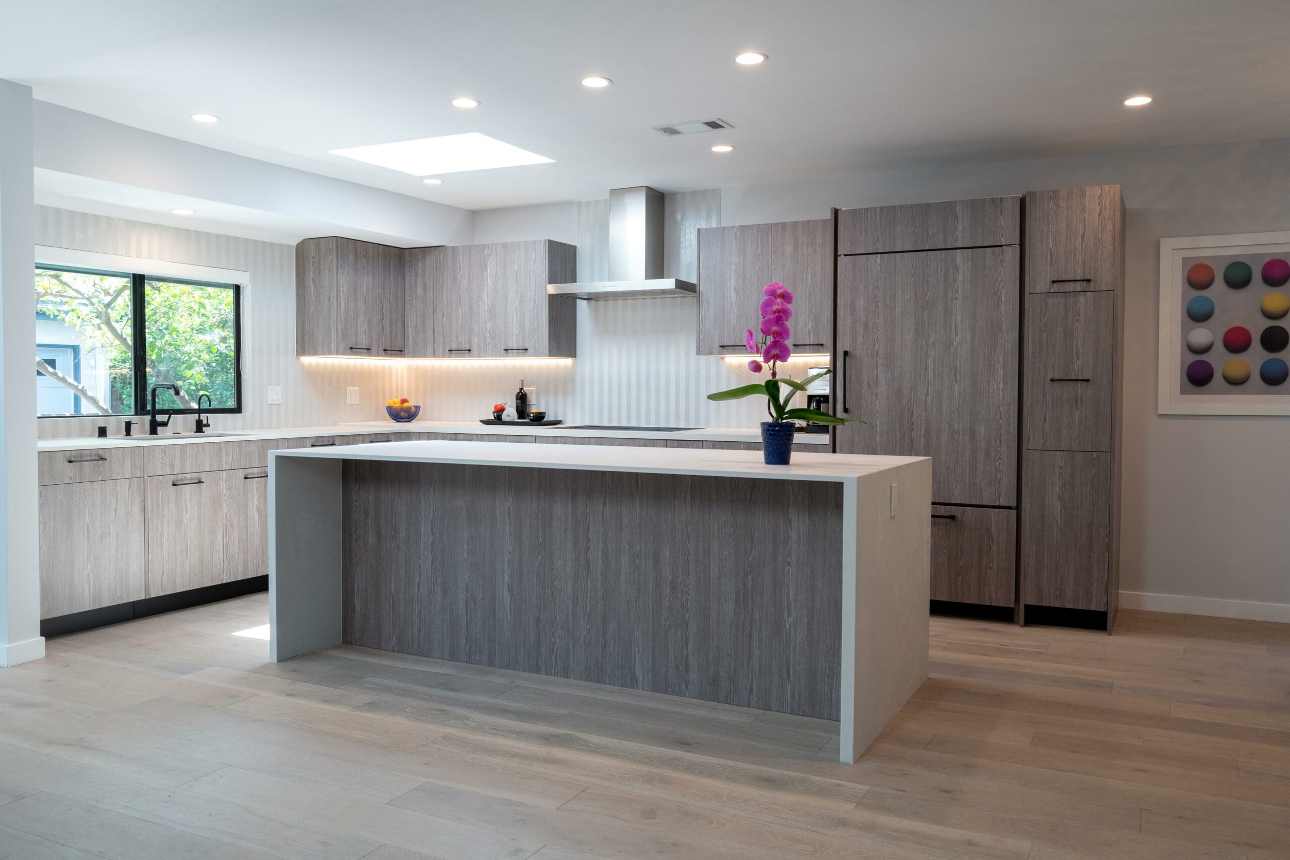 Modern kitchen interior with wood finishes and orchid.