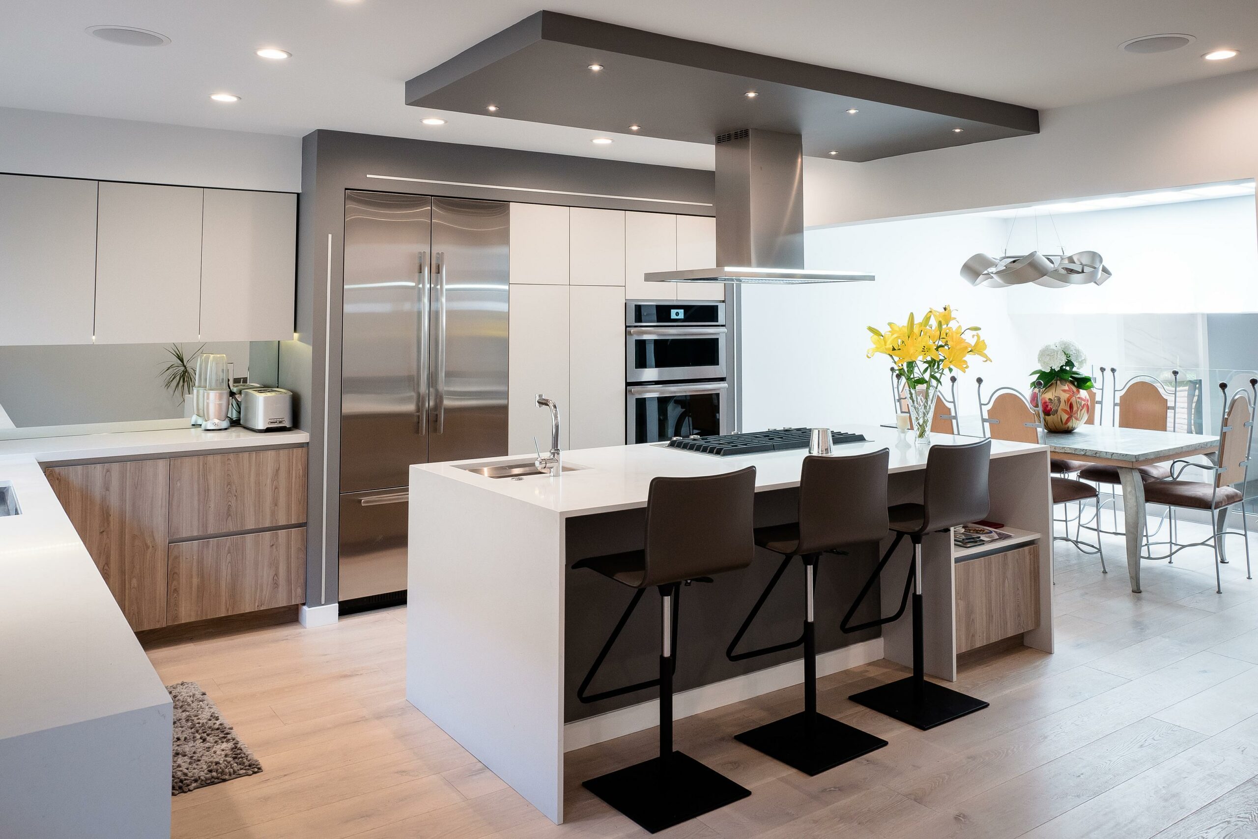 Modern kitchen interior with island and stainless appliances.
