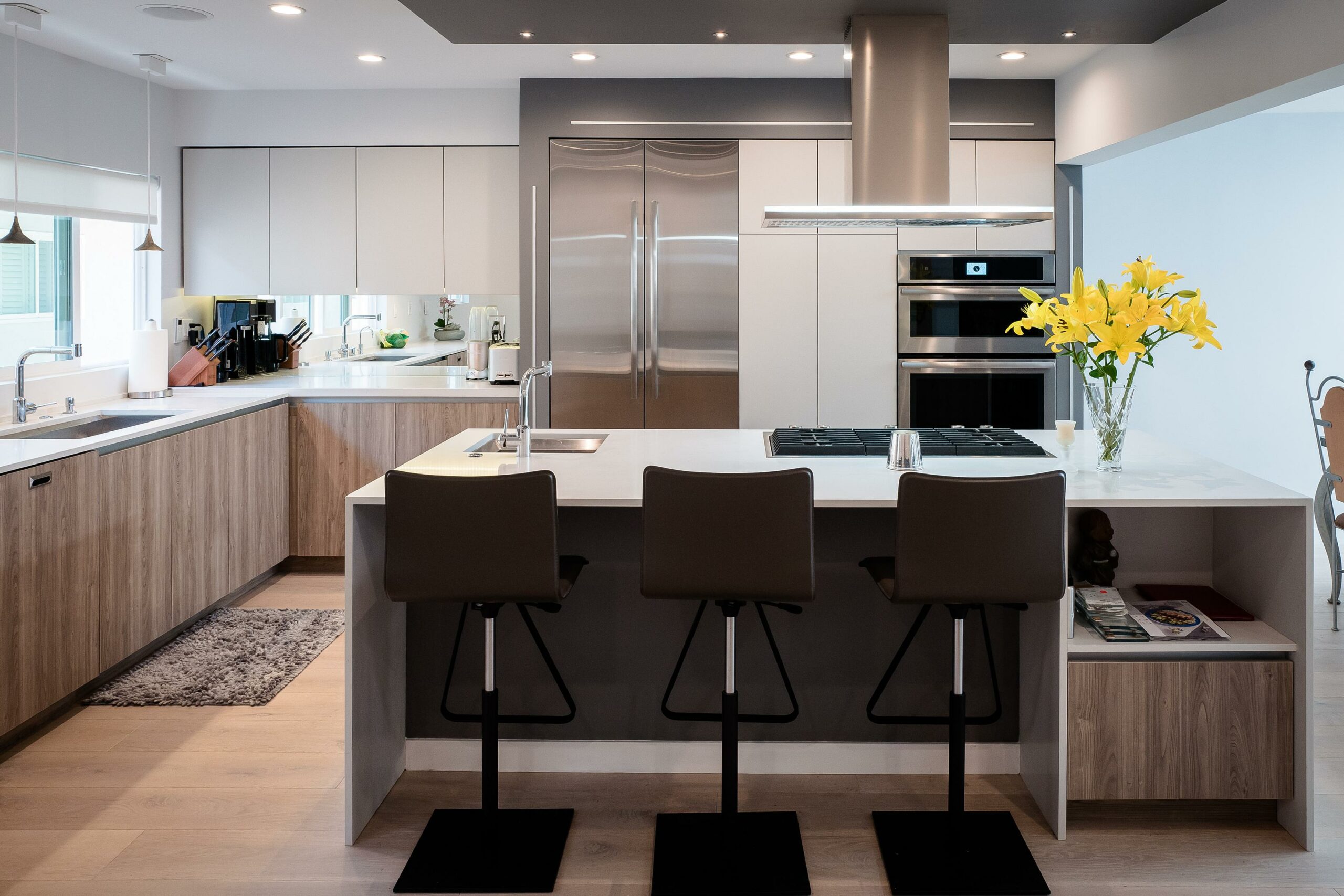 Modern kitchen interior with island and stainless steel appliances.