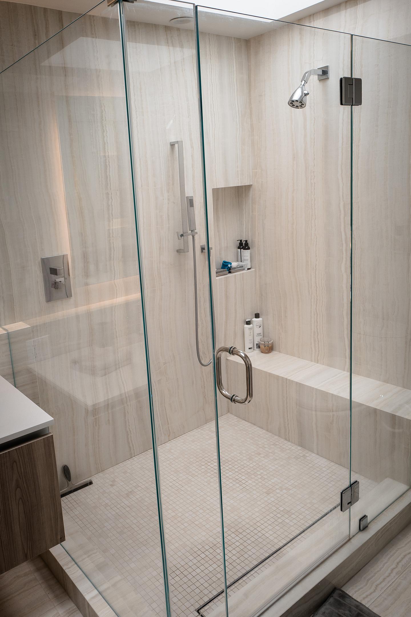 Modern bathroom with glass shower enclosure.