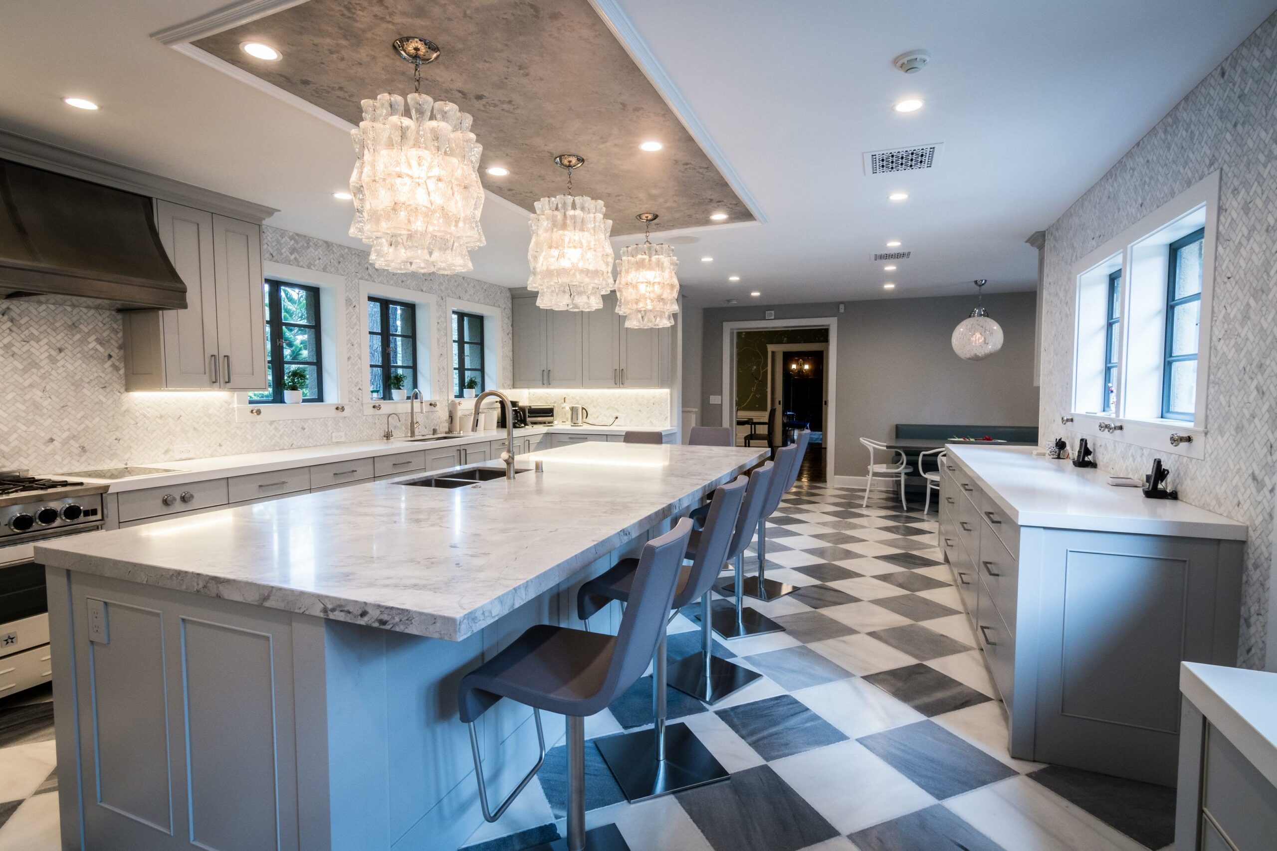 Elegant kitchen with checkered floor and modern lighting fixtures.