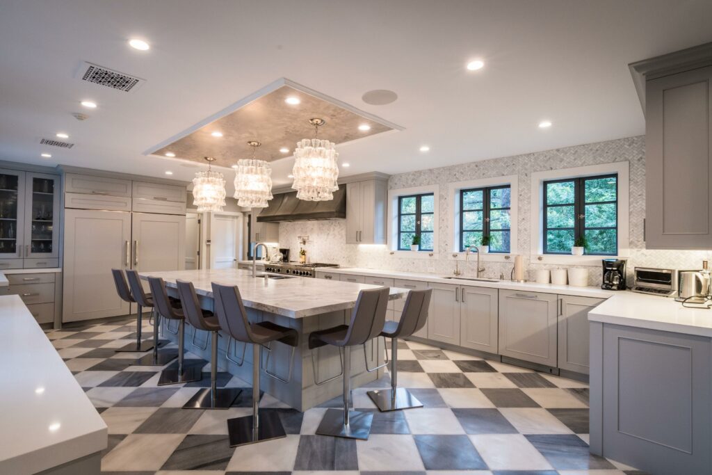 Modern kitchen with island and elegant lighting.