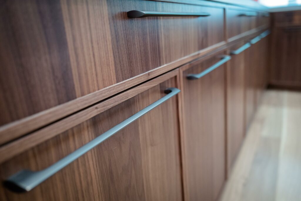 Wooden kitchen cabinets with modern handles.