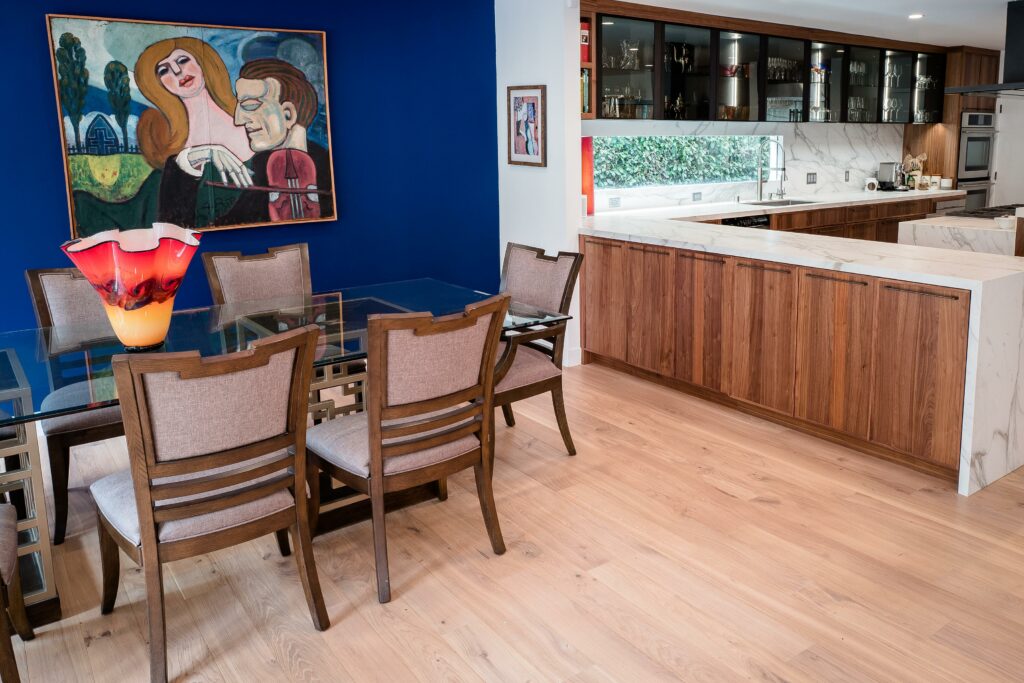 Modern kitchen interior with dining area and colorful art.