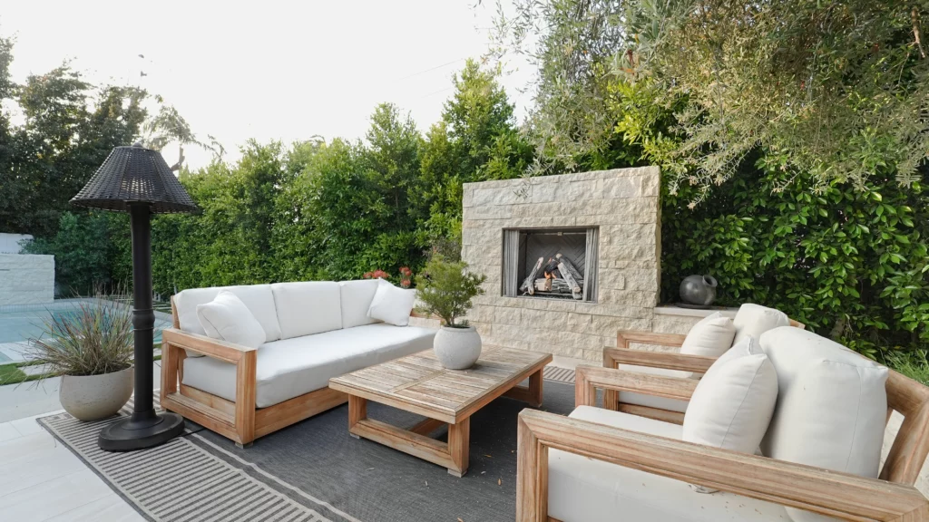 Outdoor patio with fireplace and furniture.