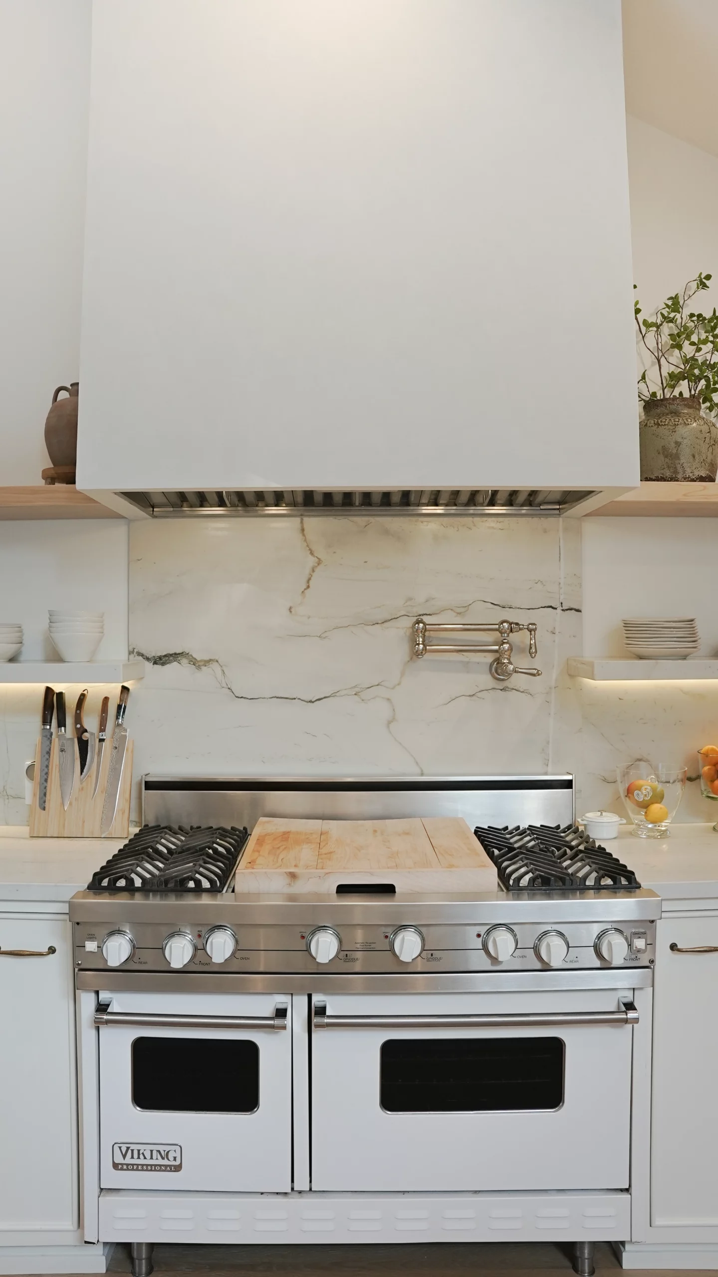 Modern kitchen with marble backsplash and Viking stove