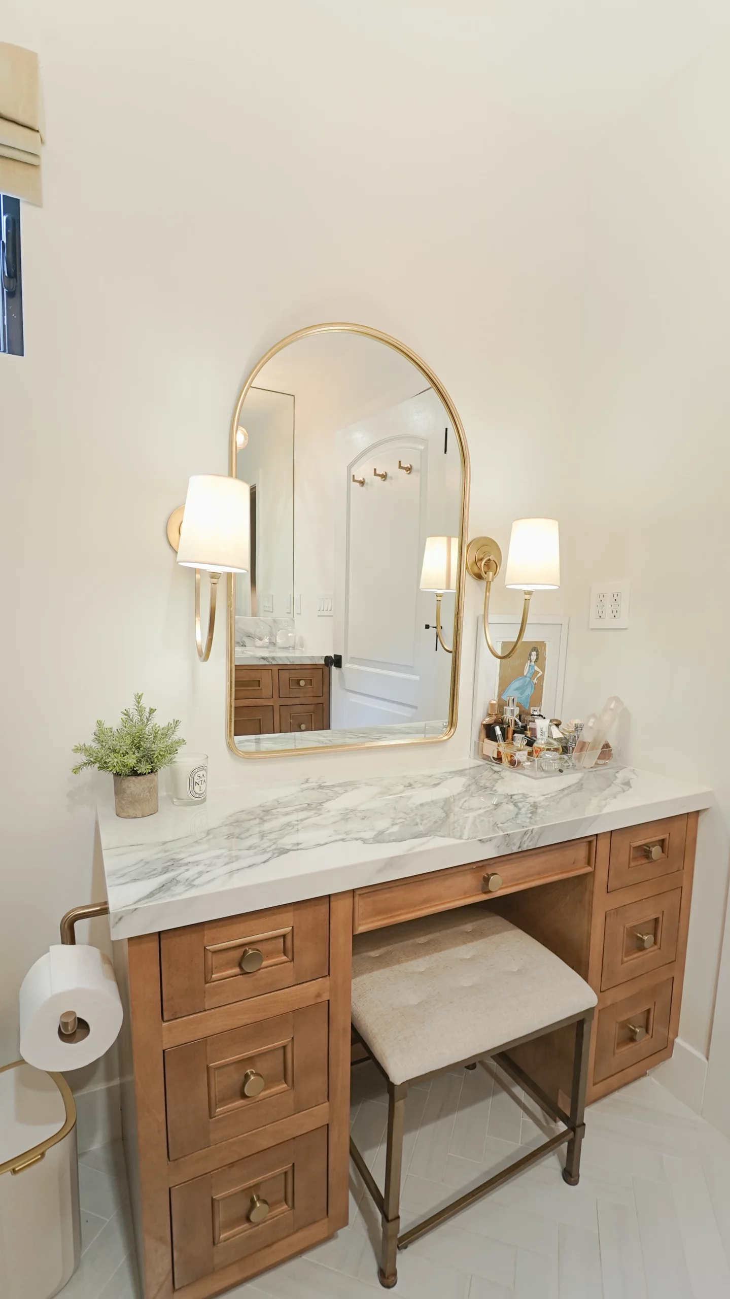 Elegant bathroom vanity with mirror and warm lighting.