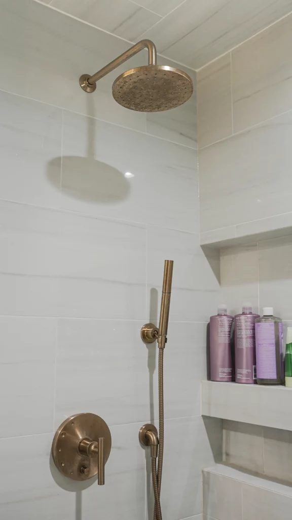 Modern showerhead in tiled bathroom interior.